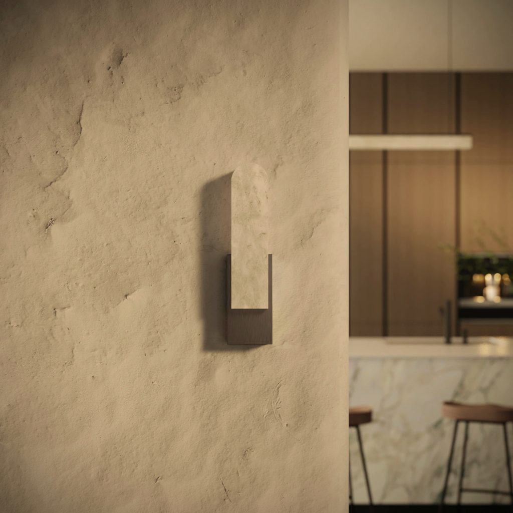 Sculptural wall light on textured plaster